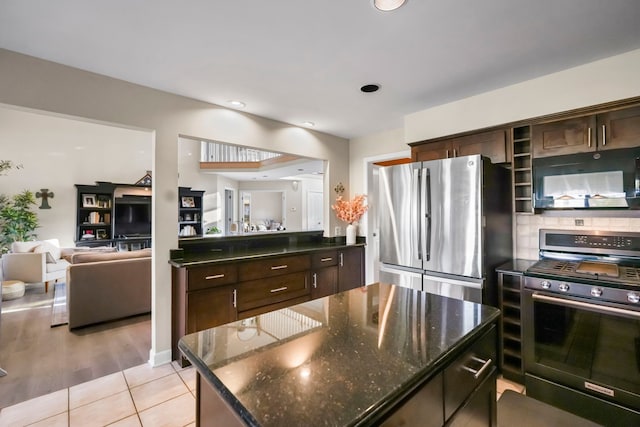 47352 Dove Ct, Shelby Twp, MI 48315 - kitchen featuring stainless steel appliances, dark brown cabinets, open floor plan, a kitchen island, and backsplash