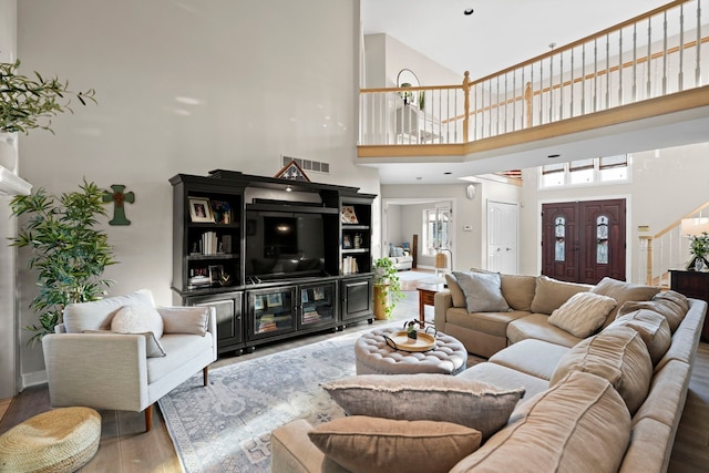 47352 Dove Ct, Shelby Twp, MI 48315 - living area featuring a high ceiling, wood finished floors, and stairs