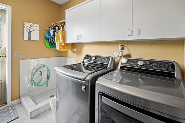 47352 Dove Ct, Shelby Twp, MI 48315 - washroom featuring cabinet space, washer and dryer, and tile patterned flooring