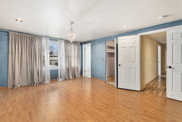 4819 Thorntree Dr, West Bloomfield, MI 48322 - spare room featuring a chandelier, light wood-type flooring, baseboards, recessed lighting, and a smoke detector