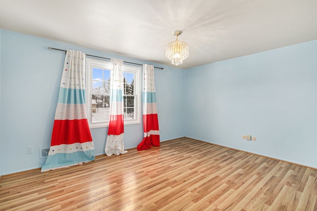 4819 Thorntree Dr, West Bloomfield, MI 48322 - spare room with a chandelier and wood finished floors