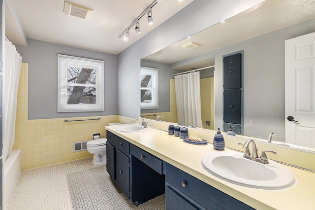 4819 Thorntree Dr, West Bloomfield, MI 48322 - full bath featuring toilet, a wainscoted wall, tile walls, double vanity, and tile patterned flooring