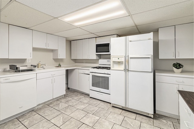 4819 Thorntree Dr, West Bloomfield, MI 48322 - kitchen with white appliances, a paneled ceiling, a sink, white cabinets, and light countertops
