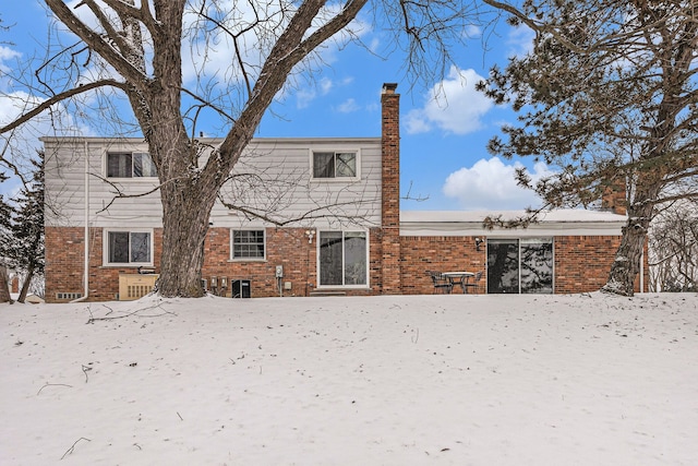 4819 Thorntree Dr, West Bloomfield, MI 48322 - snow covered property featuring a chimney and brick siding