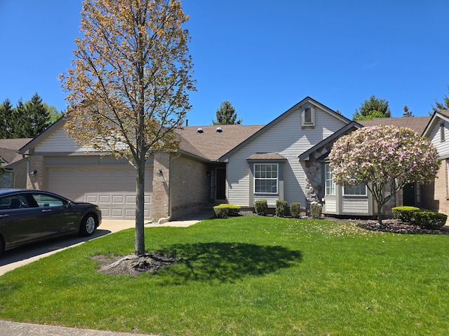 view of front facade with a garage, brick siding, a front lawn, concrete driveway, and a shingled roof