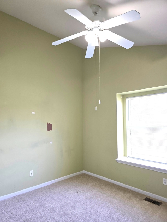 spare room with carpet flooring, baseboards, and ceiling fan