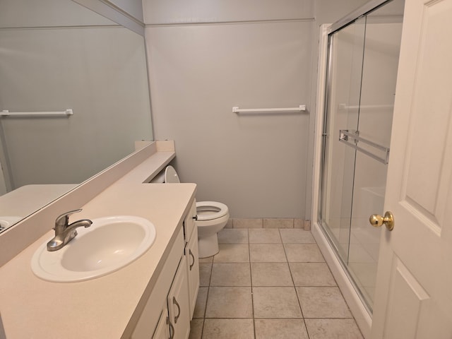 full bath with a stall shower, vanity, toilet, and tile patterned floors