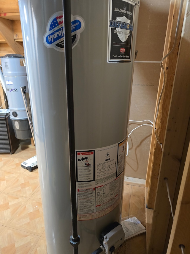 utility room featuring water heater