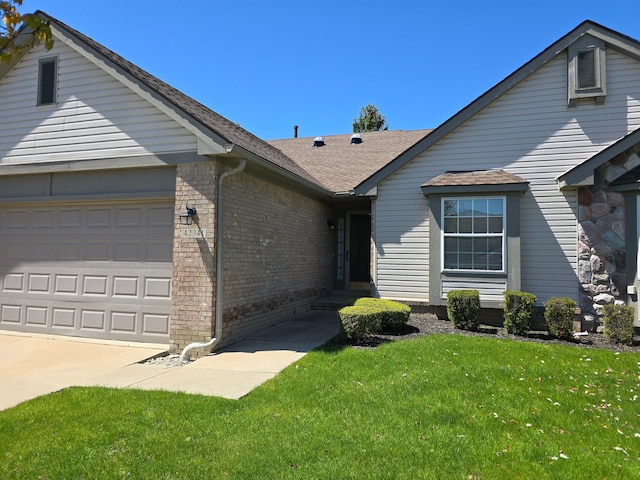 single story home with brick siding, an attached garage, a front lawn, driveway, and roof with shingles