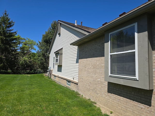 view of property exterior featuring a yard and brick siding