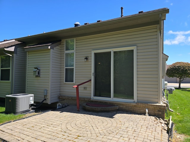back of house featuring a patio area, cooling unit, and entry steps