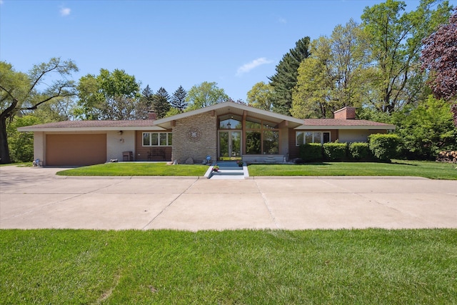 7317 Bircklan Dr, Canton, MI 48187 - view of front of house with a chimney, an attached garage, a front lawn, driveway, and brick siding