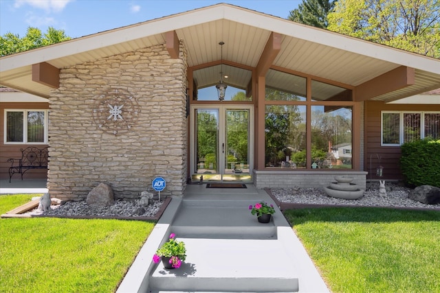 7317 Bircklan Dr, Canton, MI 48187 - property entrance with stone siding, a yard, and french doors