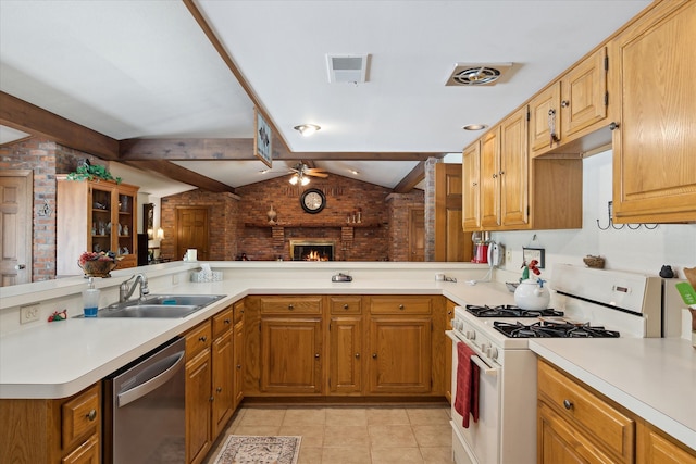7317 Bircklan Dr, Canton, MI 48187 - kitchen with gas range gas stove, a sink, dishwasher, a ceiling fan, and a brick fireplace
