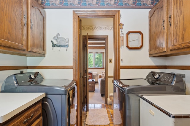 7317 Bircklan Dr, Canton, MI 48187 - laundry room featuring washing machine and dryer, cabinet space, and light tile patterned flooring