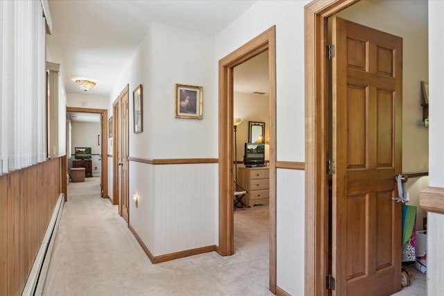 7317 Bircklan Dr, Canton, MI 48187 - hallway featuring a baseboard heating unit, light carpet, and a wainscoted wall