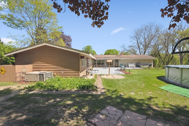 7317 Bircklan Dr, Canton, MI 48187 - rear view of property with a patio area and a covered pool