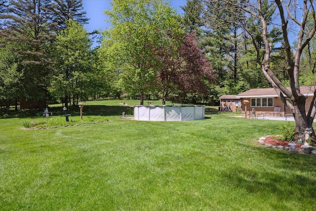 7317 Bircklan Dr, Canton, MI 48187 - view of green lawn with a covered pool and a patio area