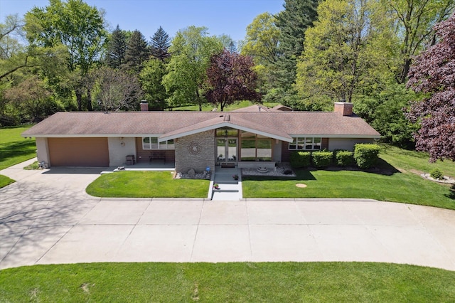 7317 Bircklan Dr, Canton, MI 48187 - view of front of home featuring a chimney, driveway, a front yard, and a garage