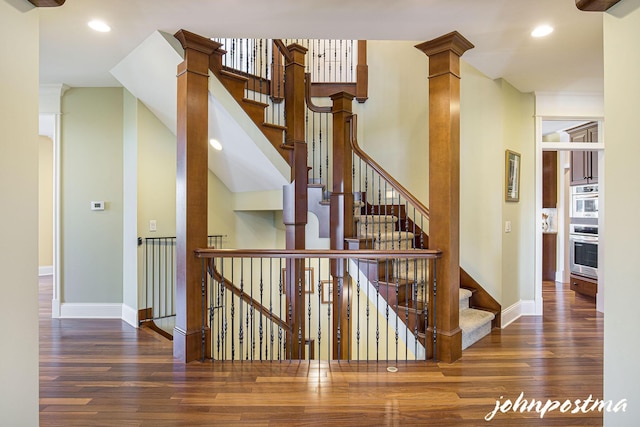 stairs with hardwood / wood-style flooring, baseboards, and recessed lighting