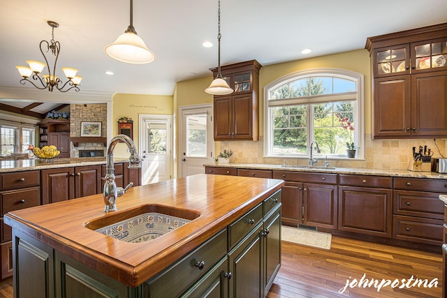 kitchen with a sink, wood counters, healthy amount of natural light, and recessed lighting