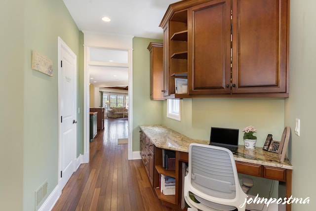 home office with dark wood finished floors, built in desk, baseboards, and recessed lighting