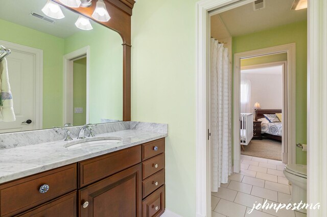 bathroom with tile patterned floors, vanity, and toilet