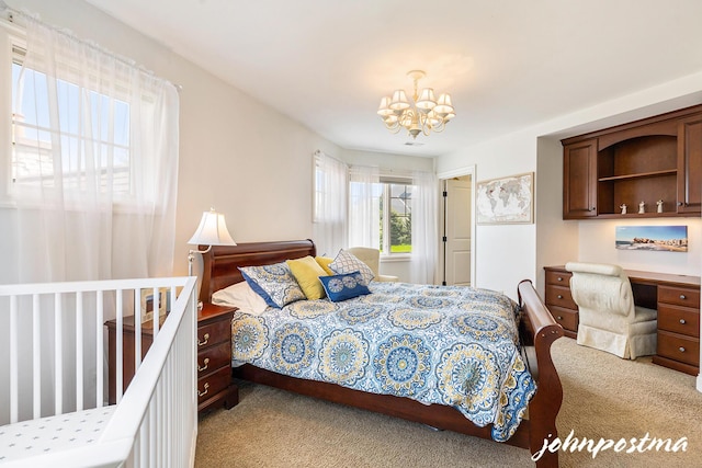 bedroom with carpet floors and a chandelier