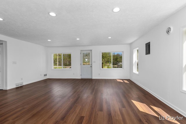 311 W Fenwick Rd, Fenwick, MI 48834 - unfurnished living room featuring recessed lighting, dark wood-style floors, baseboards, and a textured ceiling