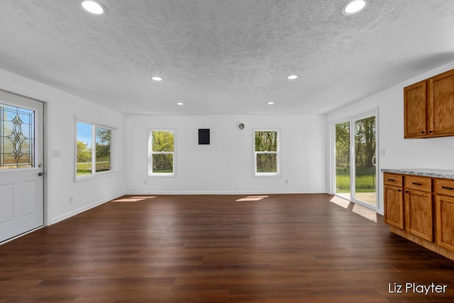 311 W Fenwick Rd, Fenwick, MI 48834 - unfurnished living room with a textured ceiling, recessed lighting, dark wood-type flooring, and baseboards