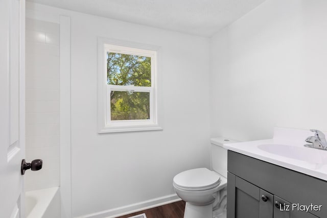 311 W Fenwick Rd, Fenwick, MI 48834 - bathroom with wood finished floors, vanity, toilet, baseboards, and washtub / shower combination