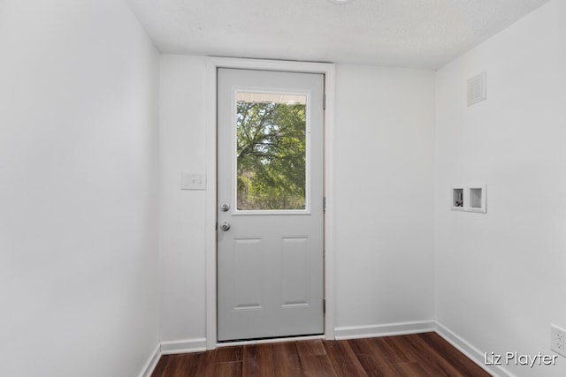 311 W Fenwick Rd, Fenwick, MI 48834 - doorway to outside featuring dark wood-type flooring and baseboards