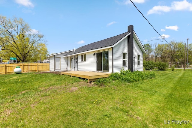 311 W Fenwick Rd, Fenwick, MI 48834 - rear view of house with a deck and a chimney