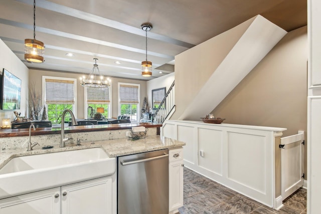 141 Paton Way, Romeo, MI 48065 - kitchen featuring dishwasher, a sink, white cabinetry, hanging light fixtures, and a decorative wall