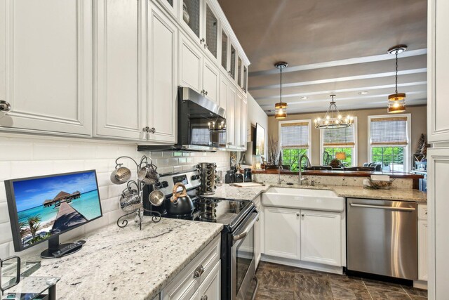 141 Paton Way, Romeo, MI 48065 - kitchen featuring stainless steel appliances, a sink, tasteful backsplash, and white cabinets