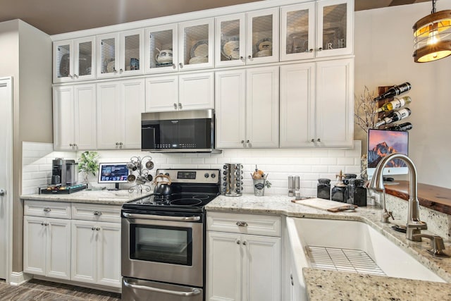 141 Paton Way, Romeo, MI 48065 - kitchen with stainless steel appliances, a sink, white cabinets, decorative backsplash, and glass insert cabinets
