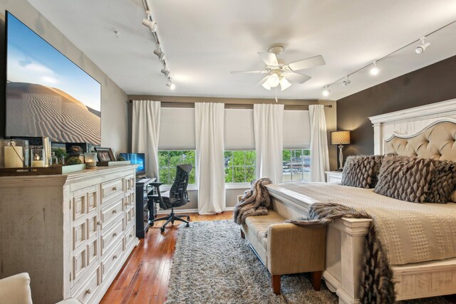 141 Paton Way, Romeo, MI 48065 - bedroom with rail lighting, an office area, and wood finished floors