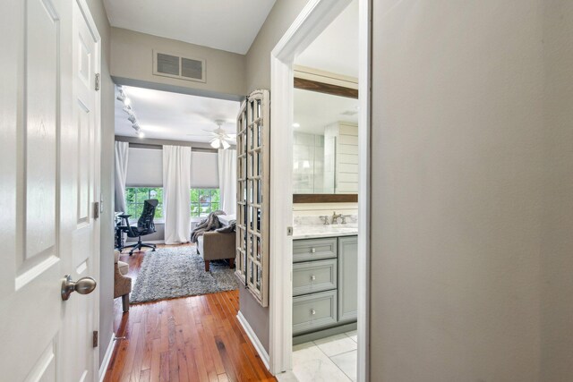 141 Paton Way, Romeo, MI 48065 - hall featuring light wood-style flooring, a desk, and a sink