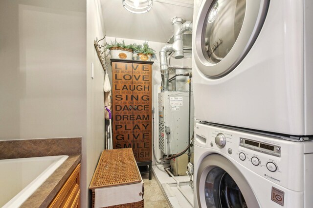 141 Paton Way, Romeo, MI 48065 - laundry area featuring stacked washer / drying machine and cabinet space