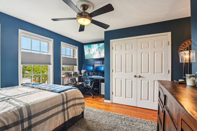 141 Paton Way, Romeo, MI 48065 - bedroom featuring light wood-style flooring, an office area, a closet, and ceiling fan