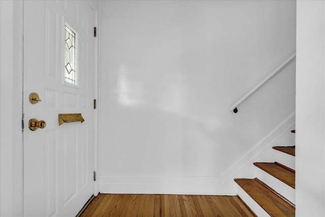 foyer featuring stairway and wood finished floors