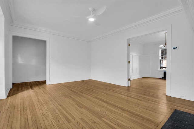 unfurnished living room featuring a ceiling fan, light wood-type flooring, and ornamental molding