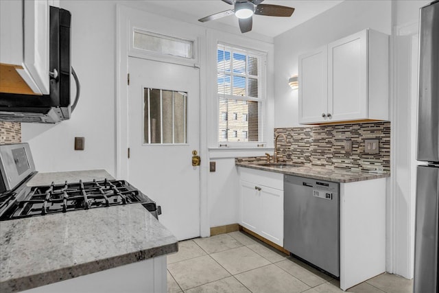 kitchen with appliances with stainless steel finishes, backsplash, ceiling fan, and white cabinets