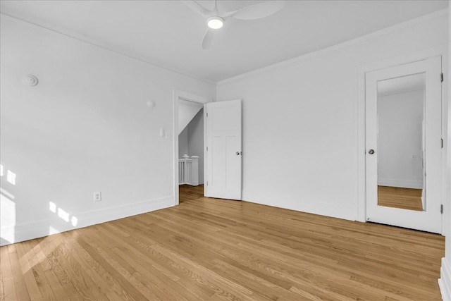 unfurnished bedroom featuring light wood-style flooring, crown molding, a ceiling fan, and baseboards