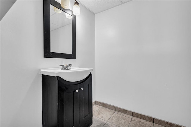 bathroom featuring vanity, baseboards, and tile patterned floors