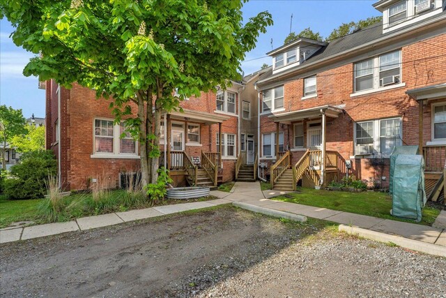 townhome / multi-family property featuring brick siding