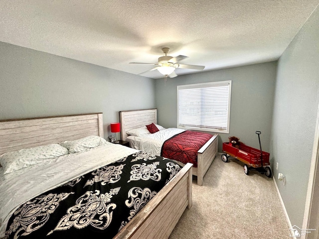 bedroom with light carpet, baseboards, ceiling fan, and a textured ceiling