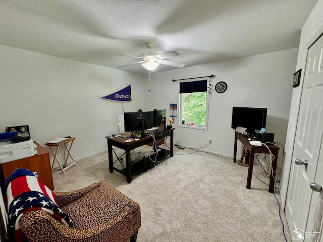 office featuring light carpet, a ceiling fan, a textured ceiling, and baseboards