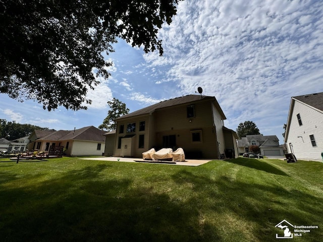 back of property with a patio and a lawn