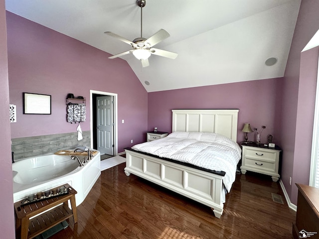 bedroom with vaulted ceiling, dark wood finished floors, and ceiling fan